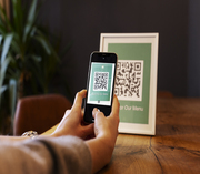 Person scanning QR code with smartphone